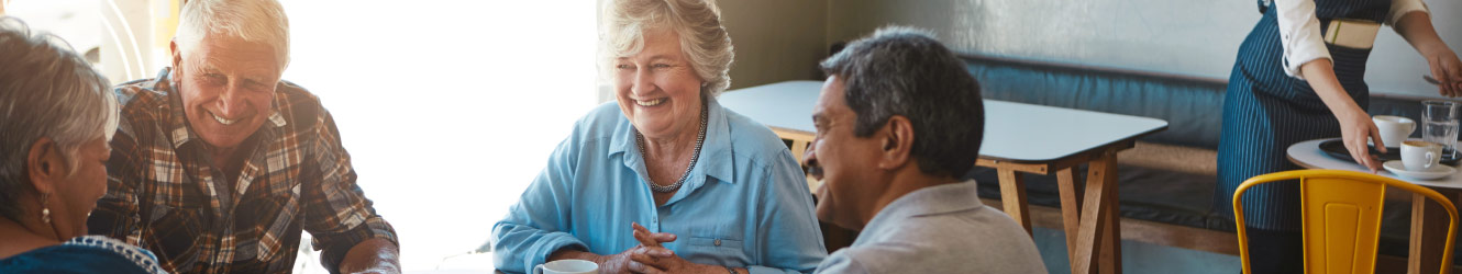 longtime friends smiling at coffee shop