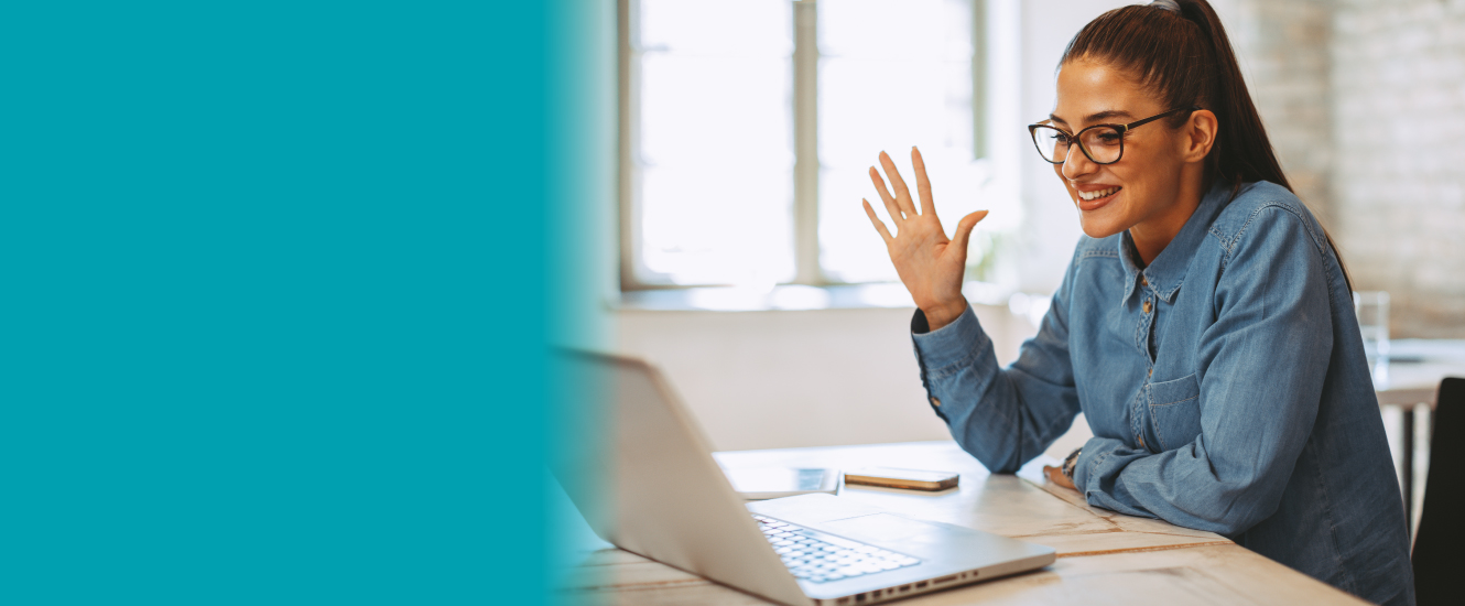 woman waving at open laptop