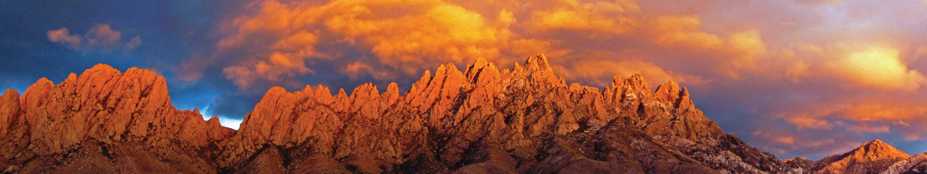 Organ mountains at sunset with orange and blue clouds