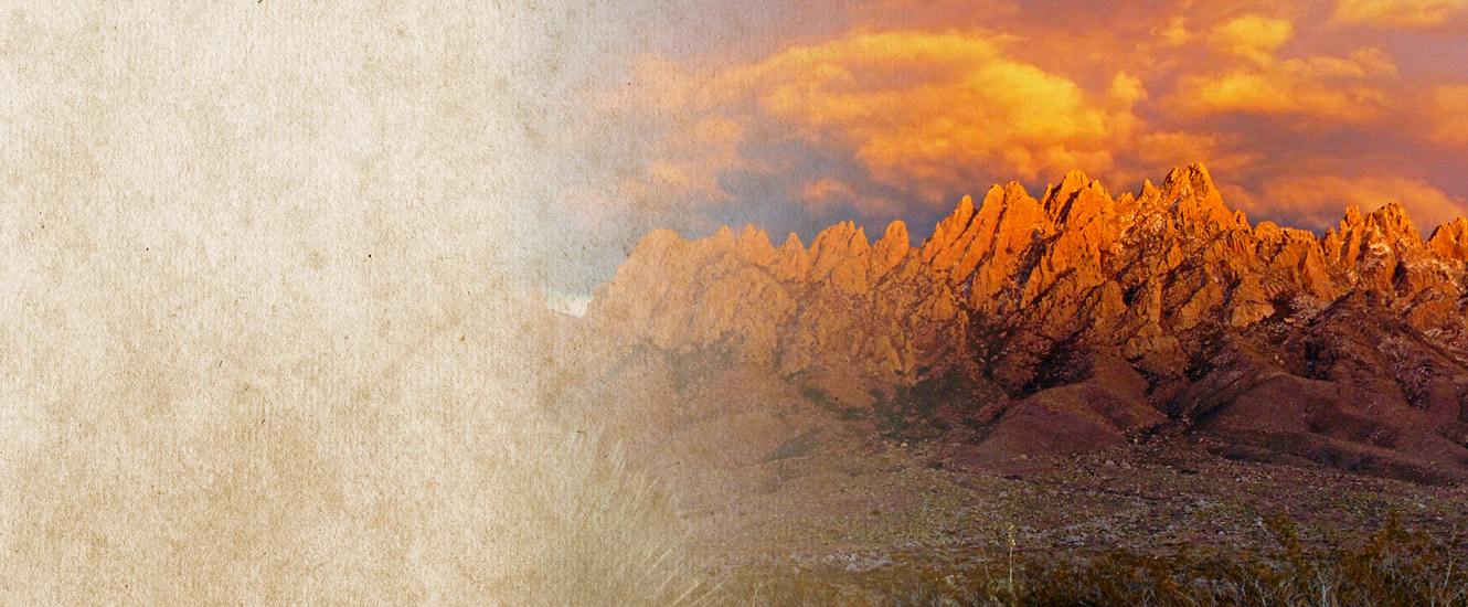 Organ Mountains at sunset with orange and blue clouds